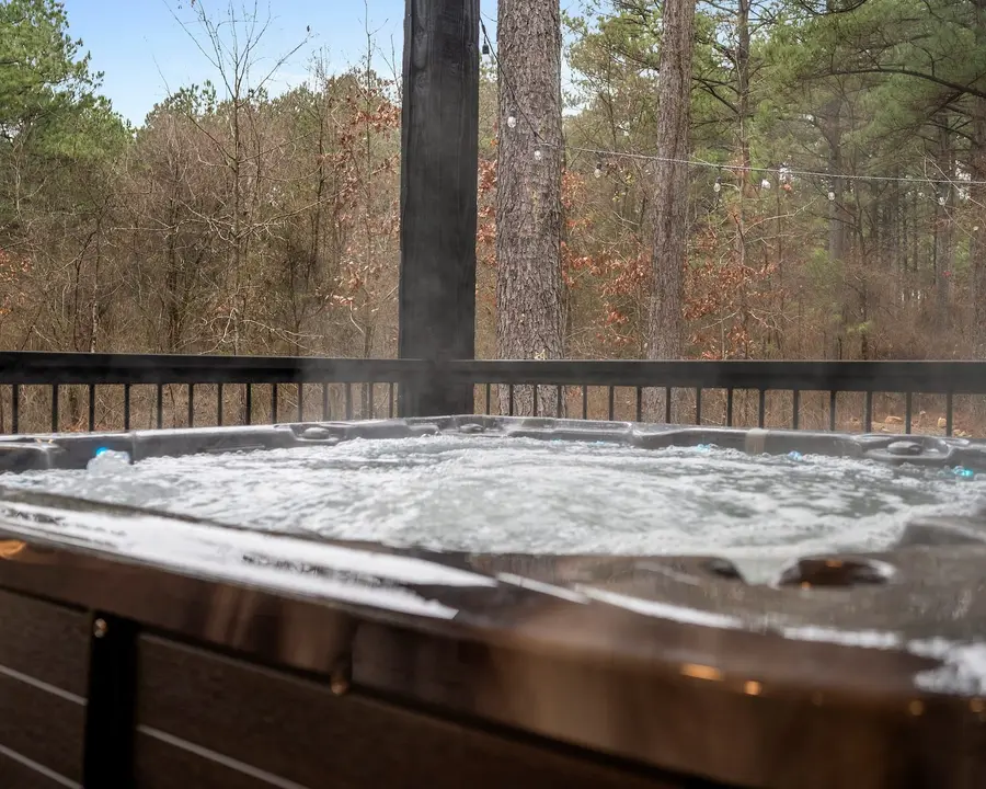 Private hot tub on the covered deck looking into the forest